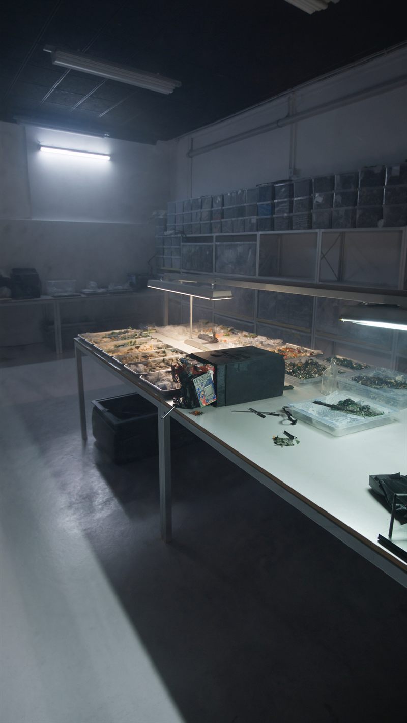 Technician testing and refurbishing electronics at a workbench